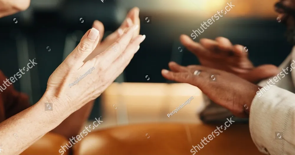 Two people's hands reaching toward each other while they talk