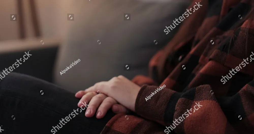 A hand resting on another person's hand in comfort
