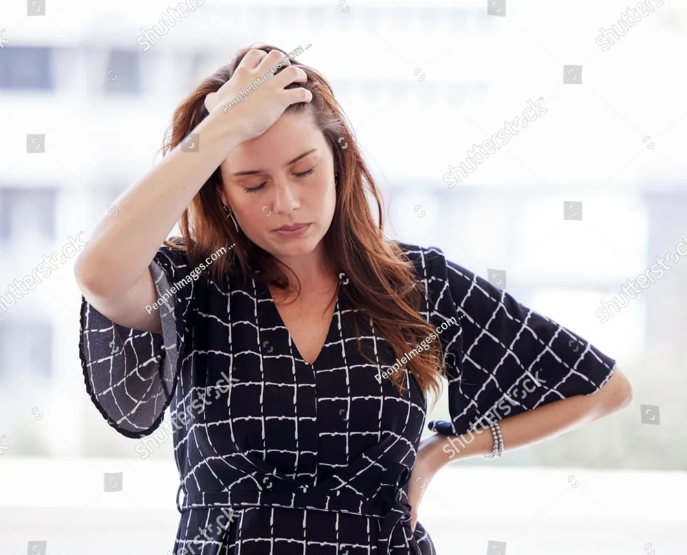A woman holding her head, overwhelmed
