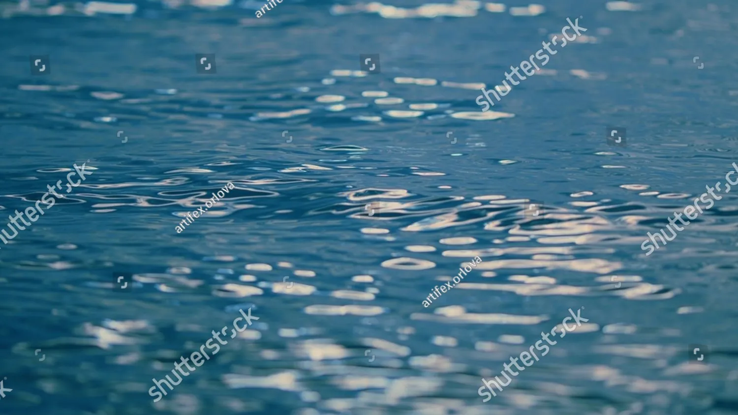 Sunlight glittering on calm blue water